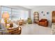 Bright living room with large windows and eclectic, charming decor, including wicker furniture and a sunlit ambiance at 5724 25Th W St, Bradenton, FL 34207