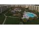 Aerial view of the condo community with swimming pool and pond at 5780 Midnight Pass Rd # 303B, Sarasota, FL 34242