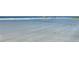 Expansive beachfront featuring calm, shallow waters, perfect for wading and enjoying the coastal scenery at 5780 Midnight Pass Rd # 303B, Sarasota, FL 34242