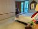 Bedroom with plush carpet, a sliding glass door, balcony access, built-in shelving and comfortable bed at 5780 Midnight Pass Rd # 303B, Sarasota, FL 34242