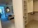 Bedroom with an open door showcasing the closet, plush carpet, and a sliding glass door with balcony access at 5780 Midnight Pass Rd # 303B, Sarasota, FL 34242