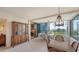 Bright living area with dining nook, custom storage, and balcony access with expansive views at 5780 Midnight Pass Rd # 303B, Sarasota, FL 34242