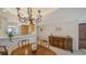 Elegant dining room features a chandelier, wood furniture, and a view into the adjacent kitchen area at 5780 Midnight Pass Rd # 303B, Sarasota, FL 34242
