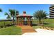 This gazebo is in a manicured lawn and garden area at 5780 Midnight Pass Rd # 303B, Sarasota, FL 34242