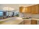 Kitchen with wood cabinetry and white countertops, overlooking the living space at 5780 Midnight Pass Rd # 303B, Sarasota, FL 34242