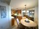 Bright kitchen with wooden cabinets and countertops, adjacent dining area with a round table and mirrored wall at 5780 Midnight Pass Rd # 303B, Sarasota, FL 34242