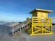 Bright yellow lifeguard stand on a sandy beach, providing safety and a clear view of the beautiful ocean at 5780 Midnight Pass Rd # 303B, Sarasota, FL 34242