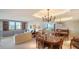 Spacious living room and dining area with built-in shelving, large windows, and comfortable seating arrangement at 5780 Midnight Pass Rd # 303B, Sarasota, FL 34242
