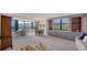 Inviting living space with dining areas, built-in shelving, and expansive windows showcasing exterior views at 5780 Midnight Pass Rd # 303B, Sarasota, FL 34242