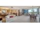 Open living area with dining areas, comfortable seating, and balcony access with picturesque views at 5780 Midnight Pass Rd # 303B, Sarasota, FL 34242