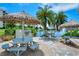 Inviting picnic area with tiki umbrellas, a grill, and a serene water view provides a relaxing outdoor experience at 5780 Midnight Pass Rd # 303B, Sarasota, FL 34242