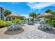 Community picnic area featuring multiple tables with tiki hut umbrellas for shade, as well as a built-in grill at 5780 Midnight Pass Rd # 303B, Sarasota, FL 34242
