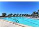 Large outdoor pool with clear blue water, multiple lounge chairs, and tropical palm tree landscaping at 5780 Midnight Pass Rd # 303B, Sarasota, FL 34242