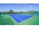 Well-maintained blue and green tennis courts surrounded by green fencing and landscaping at 5780 Midnight Pass Rd # 303B, Sarasota, FL 34242
