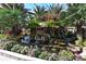 Beautiful rock water feature with vibrant flowers and lush plants create a tranquil ambiance at 5780 Midnight Pass Rd # 303B, Sarasota, FL 34242