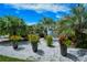 Scenic water feature with diverse plants and flowers, surrounded by palm trees, adding natural beauty to the property at 5780 Midnight Pass Rd # 303B, Sarasota, FL 34242