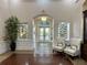 Beautiful lobby with a large plant, decorative windows, and comfortable seating at 6713 Stone River Rd # 206, Bradenton, FL 34203