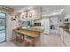 Bright kitchen featuring stone countertops, white cabinetry, and a breakfast bar with stool seating at 7102 W 18Th W Ave, Bradenton, FL 34209