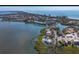 Aerial view of a stunning waterfront estate with a private dock, pool, and lush landscaping at 741 Hideaway Bay Dr, Longboat Key, FL 34228