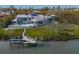 Aerial view of the home on the water with a dock and in-ground pool at 741 Hideaway Bay Dr, Longboat Key, FL 34228