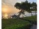 Landscaped backyard with water access and a sunset view at 741 Hideaway Bay Dr, Longboat Key, FL 34228