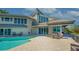 Modern home with a beautiful outdoor pool, deck area, and waterfront views at 741 Hideaway Bay Dr, Longboat Key, FL 34228