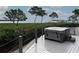 Outdoor deck featuring a relaxing hot tub with serene waterfront views and lush landscaping at 741 Hideaway Bay Dr, Longboat Key, FL 34228