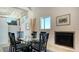 Bright dining room featuring modern table set, fireplace, and access to upstairs at 741 Hideaway Bay Dr, Longboat Key, FL 34228