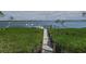 A walkway leading to the dock over lush greenery at 741 Hideaway Bay Dr, Longboat Key, FL 34228
