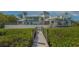 Charming waterfront home with a private dock, lush landscaping, and secure gated access at 741 Hideaway Bay Dr, Longboat Key, FL 34228