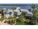 Stunning waterfront home with lush landscaping and a metal roof offers luxury living at 741 Hideaway Bay Dr, Longboat Key, FL 34228