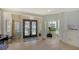 Welcoming foyer with elegant decor, tile flooring, and a view of lush greenery through the windows at 741 Hideaway Bay Dr, Longboat Key, FL 34228