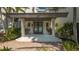 Inviting front entrance with double doors, columns, and well-manicured landscaping at 741 Hideaway Bay Dr, Longboat Key, FL 34228