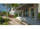 Elegant front entrance with double doors, white columns, and a brick walkway surrounded by greenery at 741 Hideaway Bay Dr, Longboat Key, FL 34228