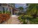 Charming front entrance with a brick pathway, lush greenery, and a welcoming facade at 741 Hideaway Bay Dr, Longboat Key, FL 34228