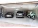 Spacious three car garage featuring a boat, bike, and car with epoxy floor at 741 Hideaway Bay Dr, Longboat Key, FL 34228
