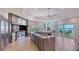 Chef's kitchen with stainless steel appliances, expansive island, and ocean views at 741 Hideaway Bay Dr, Longboat Key, FL 34228