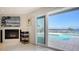 Cozy living room with fireplace and sliding doors offering access to pool and waterfront at 741 Hideaway Bay Dr, Longboat Key, FL 34228
