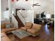 Bright living room features tall ceilings, large windows, hardwood floors, and comfortable seating options at 741 Hideaway Bay Dr, Longboat Key, FL 34228