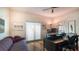 Bright office features a sofa, dark desk, a ceiling fan, and a large window that lets in natural light at 741 Hideaway Bay Dr, Longboat Key, FL 34228
