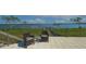 Outdoor patio area featuring comfortable wicker chairs and amazing water views at 741 Hideaway Bay Dr, Longboat Key, FL 34228
