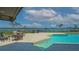 Tranquil pool area with comfortable seating and picturesque views of the bay at 741 Hideaway Bay Dr, Longboat Key, FL 34228
