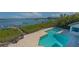 Elevated view of backyard with a pool and beautiful bay views at 741 Hideaway Bay Dr, Longboat Key, FL 34228