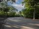 Paved road lined with lush greenery, trees and nature preserve in this private and beautiful community at 741 Hideaway Bay Dr, Longboat Key, FL 34228
