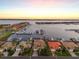 Stunning waterfront homes with private docks along a tranquil canal at sunset at 1007 3Rd E St, Palmetto, FL 34221