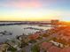 An aerial view of a residential neighborhood with a boat marina at sunset at 1007 3Rd E St, Palmetto, FL 34221