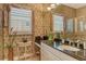 A bathroom featuring custom vanity, granite counters, and shuttered windows, creating a spa-like retreat at 1007 3Rd E St, Palmetto, FL 34221