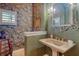 Half bathroom featuring elegant fixtures, unique wallpaper, and decorative mirror at 1007 3Rd E St, Palmetto, FL 34221