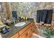 Unique bathroom with granite countertops, leaf and leopard print wallpaper, and black towels with leopard print at 1007 3Rd E St, Palmetto, FL 34221