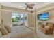 Relaxing bedroom with a wall-mounted TV and serene views from the open sliding doors to the balcony at 1007 3Rd E St, Palmetto, FL 34221
